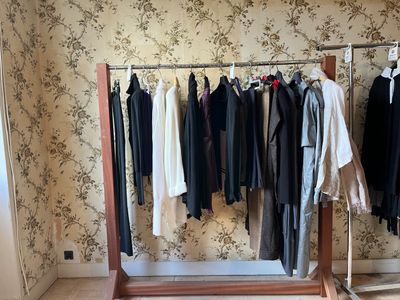 a picture of a clothes rack with clothes hanging on it
