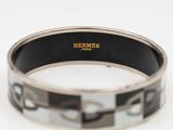 an image of a black and white bracelet on a white surface