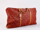 an image of a red duffel bag sitting on top of a white surface