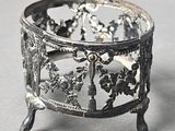 a silver plate with a bird and flowers design on it