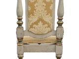 a white chair with a yellow cushion on top of it