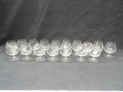 twelve wine glasses lined up in a row on a black background
