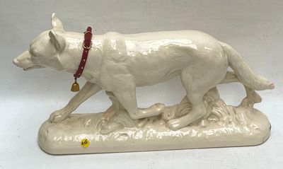 a figurine of a white dog with a red collar