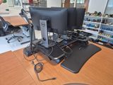 a desk with two monitors and a mouse on it