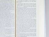 a open book on a table with a pencil in it
