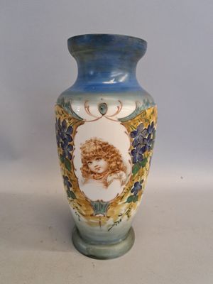 a blue vase with a picture of a woman on it