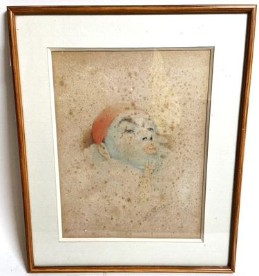 tableau représentant le visage d'un homme coiffé d'un chapeau, dans un cadre en bois