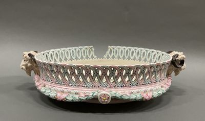 a white bowl with pink and green designs on it