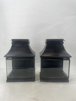a pair of black metal lanterns on a white background