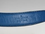 a close up of a blue leather belt on a white surface