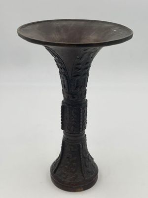 an image of a black metal pedestal with a bird on it
