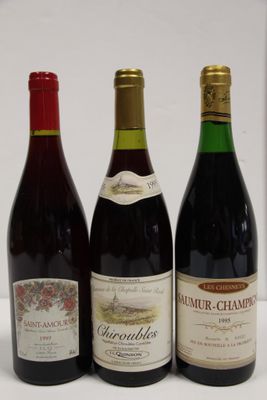 three bottles of wine are lined up on a white surface