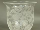 a glass vase with a floral design on it