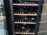 a wine cooler with many bottles of wine inside of it
