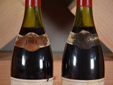 two bottles of wine that are sitting on a table
