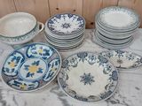 many plates and bowls sitting on a table in a room