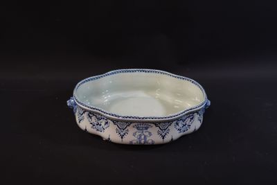 a blue and white bowl sitting on a black surface