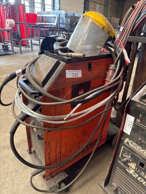 an image of a welding machine in a factory with a lot of wires