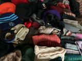 a pile of sweaters and hats on the floor