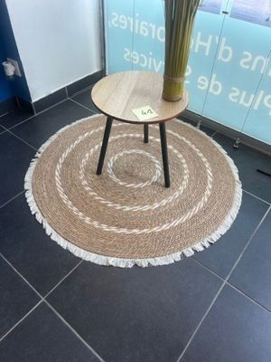 a table with a vase of flowers on it in the middle of a room