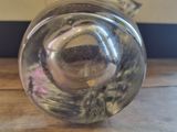 a glass vase that is sitting on a wooden table
