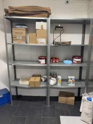 a room with shelves and boxes on the floor