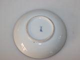 a white plate with a blue and white design on it