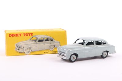 a toy car that is sitting next to a box