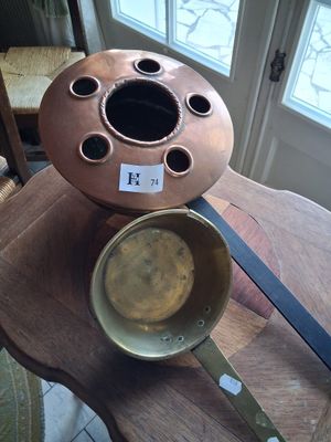 two pots sitting on a table near a window