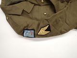 an image of a military hat with a gold arrow on it