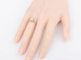 an image of a woman ' s hand with a diamond ring on it