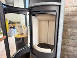 a black and white stove in a corner of a room