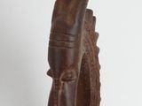 wooden sculpture of a horned head with horns on a white background