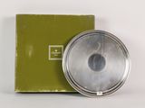 a box with a silver object in it and a box with a green box