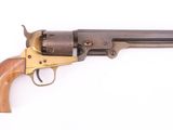 a close up of a revolver with a wooden handle on a white background