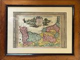an old map of europe in a wooden frame on a wall