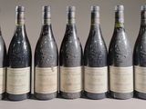 six bottles of wine are lined up in a row on a table