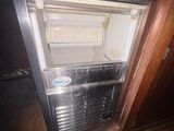 a small refrigerator in the corner of a room