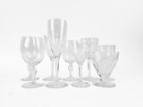 six wine glasses sitting next to each other on a white surface