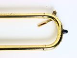 a gold colored metal object on a white surface