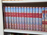 many books that are on a shelf in a book case