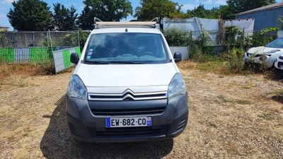 a small white van parked in a lot next to a fence
