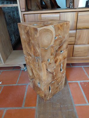 a tree stump sitting on the floor in a kitchen