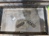 a metal box with a bunch of screws inside of it