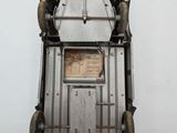 a metal clock that is hanging on the wall