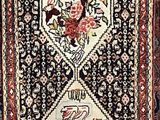 an oriental rug with a diamond design on a black ground