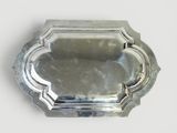 a silver tray with a decorative design on it