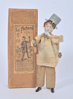 a small figurine of a man with a top hat and a cane
