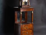 a small wooden cabinet with a clock on top of it