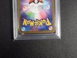 a close up of a pokemon trading card in a plastic holder